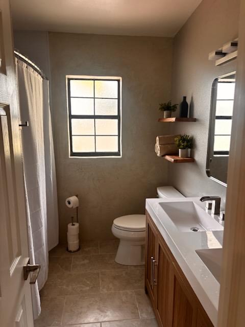 Clean bathroom with double vanity and shower